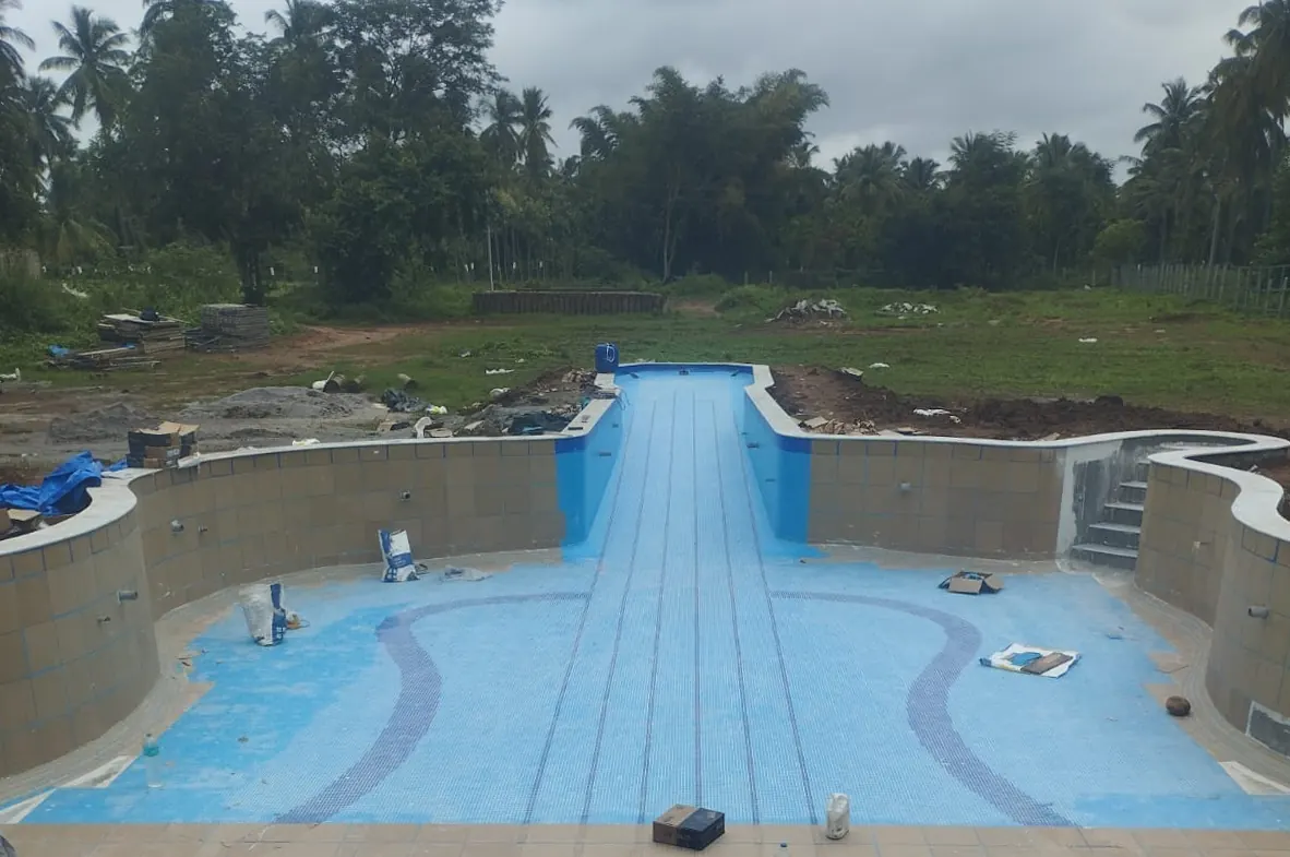 Guitar-shaped pool under construction at Mango Grove, Channapatna