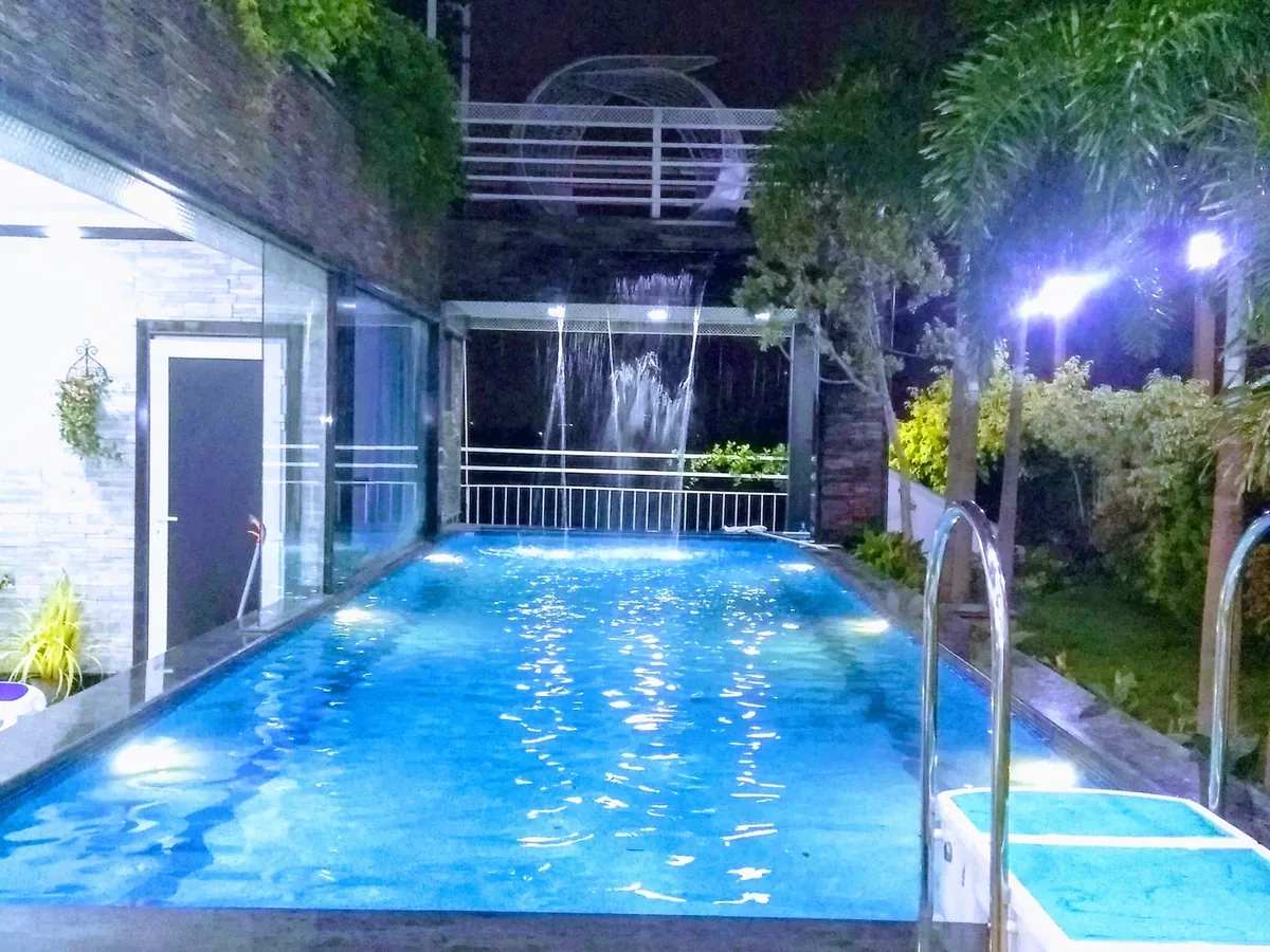Illuminated terrace pool at night at Genesis Grand, Bangalore
