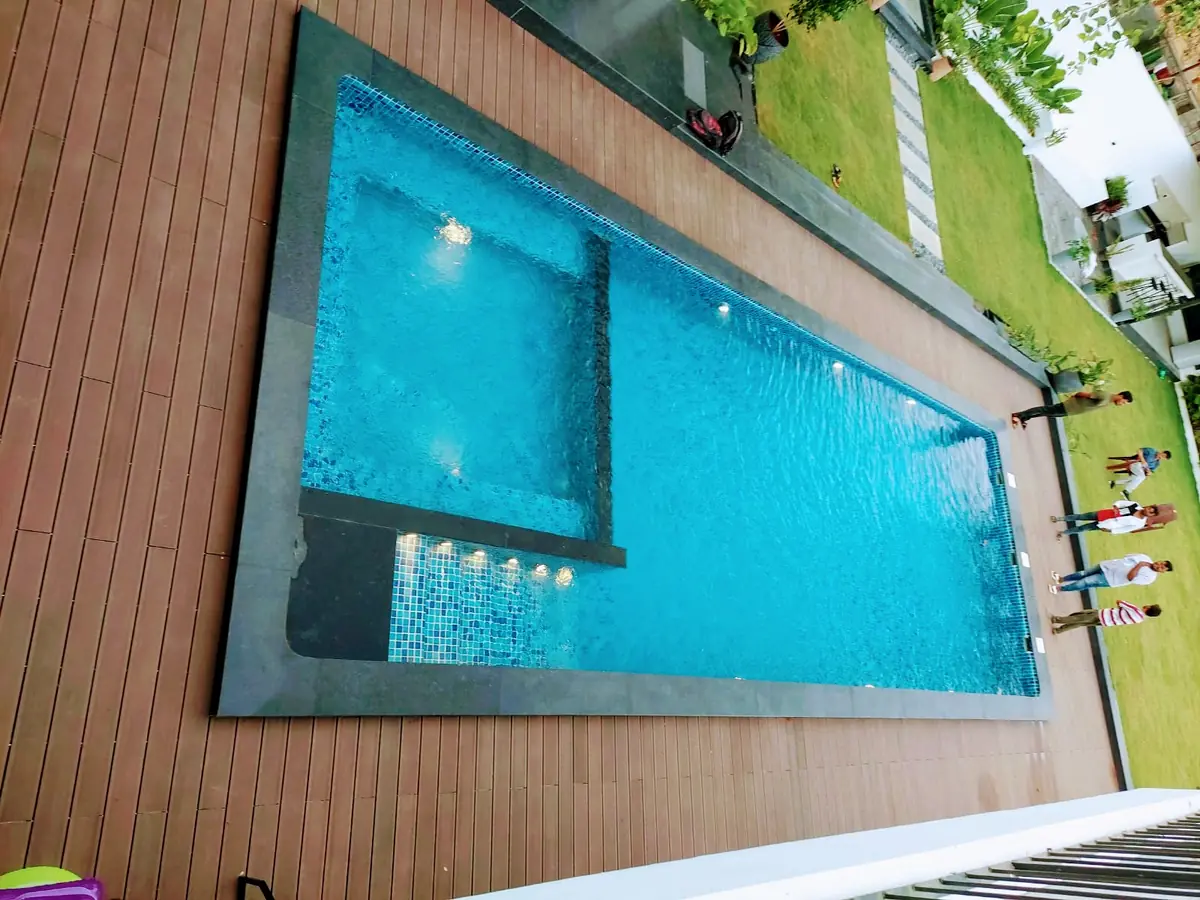 Pool with an attached spa and timber deck at Boho White Manor