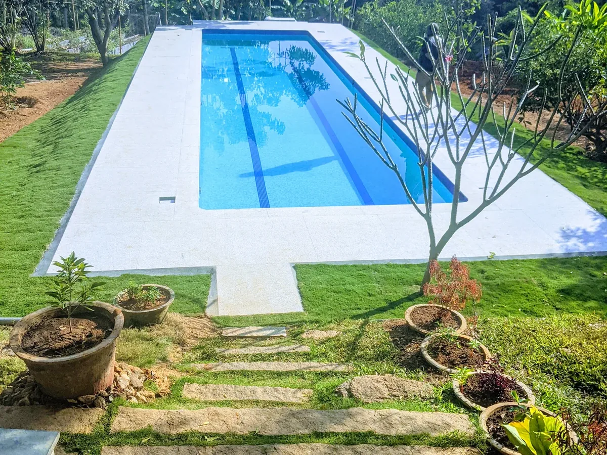 Lap pool set in a landscaped garden at Prasad Residence, Manchinbele