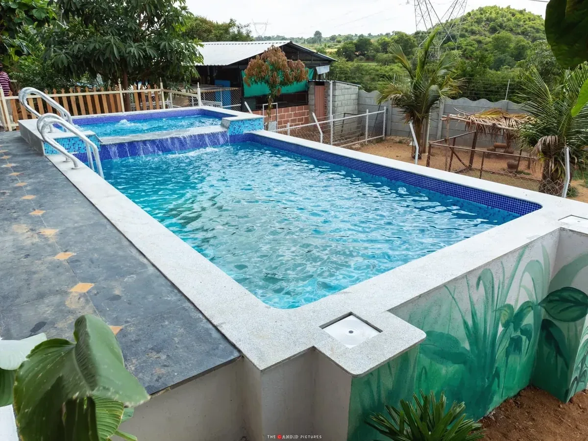 Raised pool with a spa spillover at Raj Residence, Doddaballapura